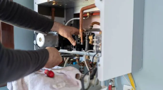 Home appliance repairs being performed by a technician on a household unit